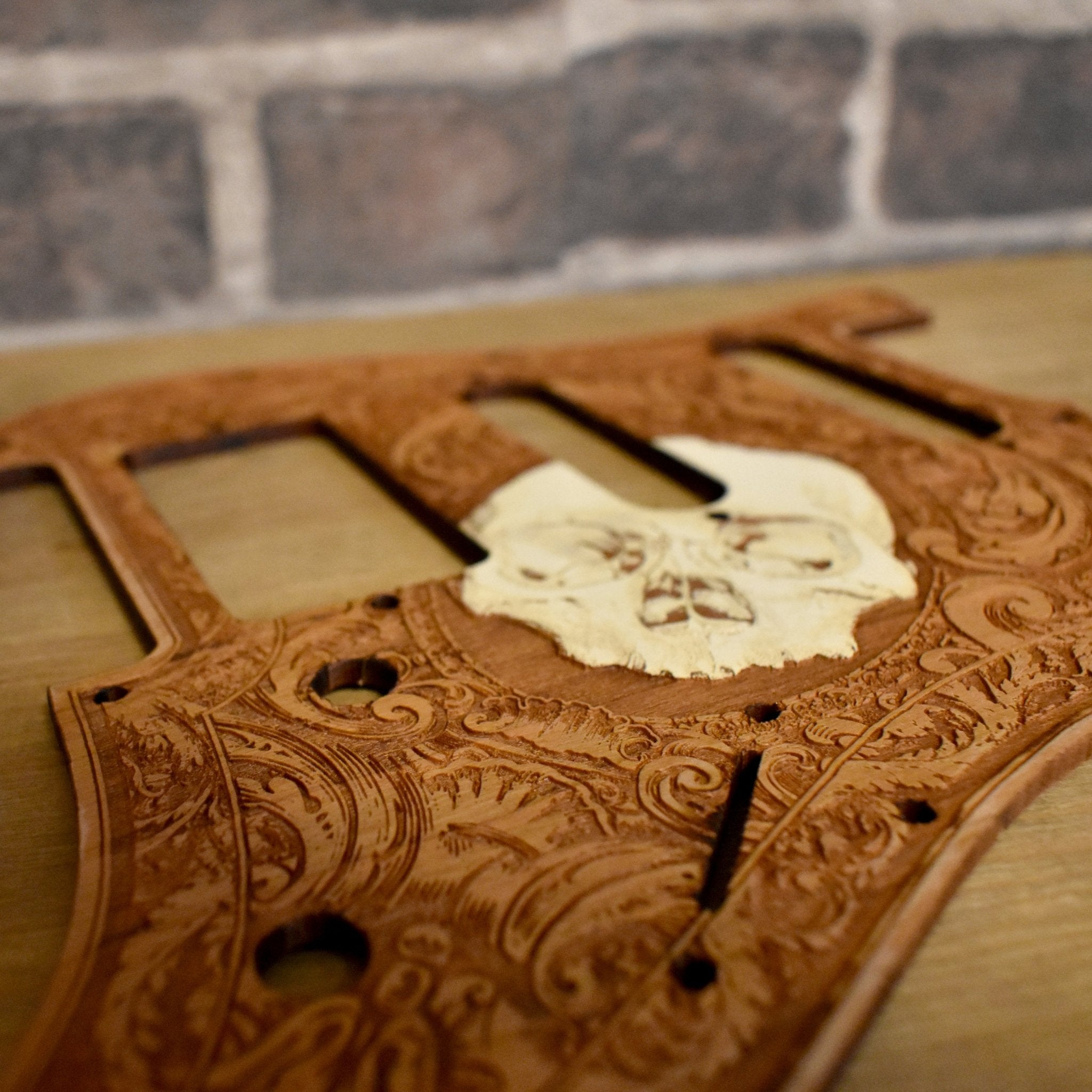 Installed Fender Stratocaster pickguard with laser-engraved skull artwork