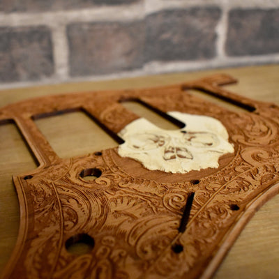 Installed Fender Stratocaster pickguard with laser-engraved skull artwork