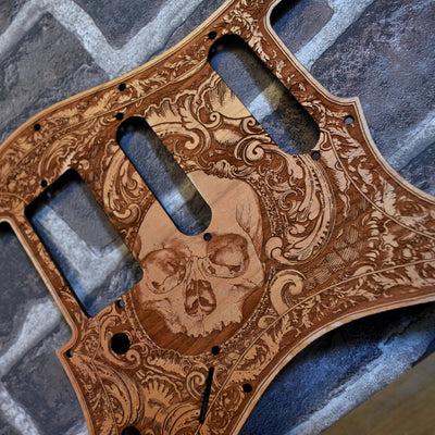 Close-up of laser-engraved cherry wood pickguard for Fender Stratocaster guitar