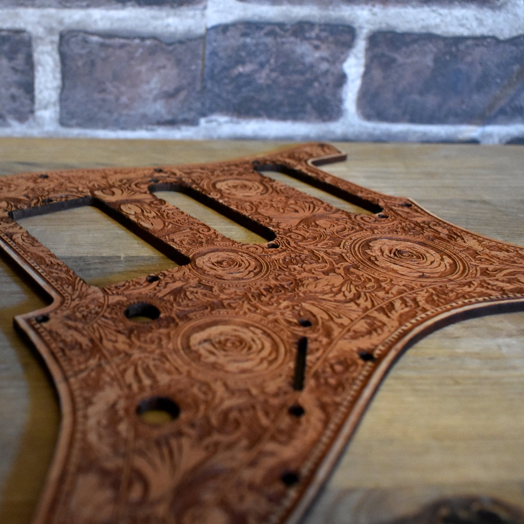 Fender Stratocaster wood pickguard with intricate laser engraved floral design