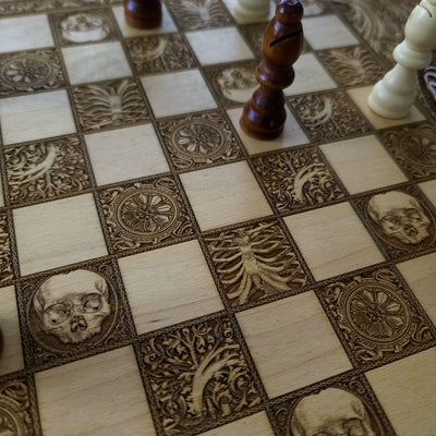 Chessboard featuring skulls, vertebrae, and anatomical engravings