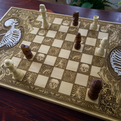 Engraved wood chessboard with skull and bone motifs