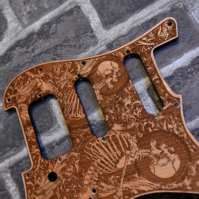 Close-up of laser-engraved cherry wood pickguard for Fender Strato HSS SSS