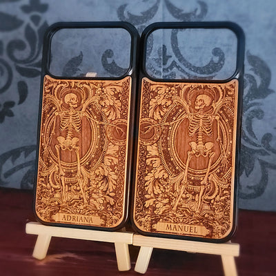 Laser-engraved wooden phone case featuring a detailed love couple skeletons with custom names 