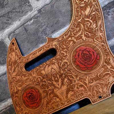 Close-up of hand-painted roses on cherry wood pickguard for Fender Telecaster