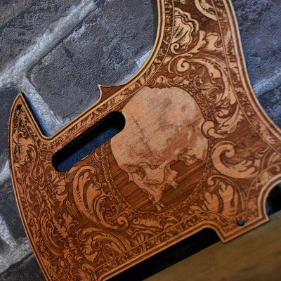 Close-up of laser-engraved skull on cherry wood Fender Telecaster pickguard