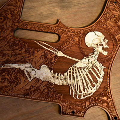 Handcrafted Fender Telecaster wood pickguard with bold skull engraving and natural finish