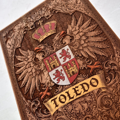 Engraved wooden wall poster featuring the historic coat of arms of Toledo, Spain, with intricate heraldic details carved into natural wood.