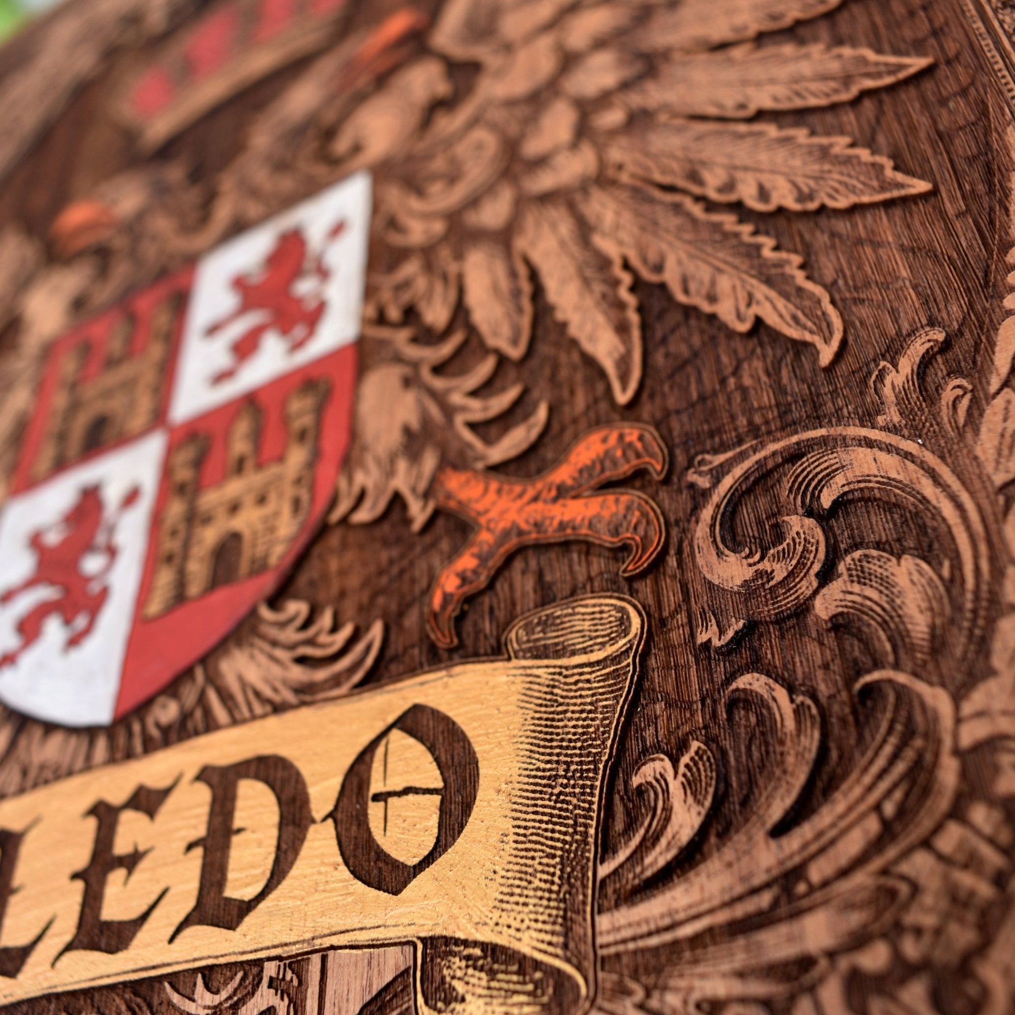 Engraved wooden wall poster featuring the historic coat of arms of Toledo, Spain, with intricate heraldic details carved into natural wood.