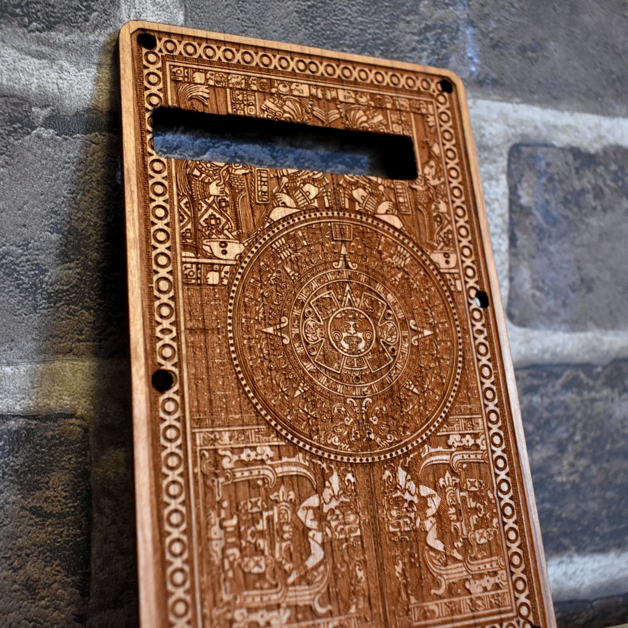 Close-up of laser-engraved Gothic skull & filigree design on cherry wood tremolo cover