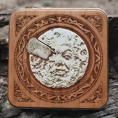 Hand-painted wireless charger with A Trip to the Moon artwork.