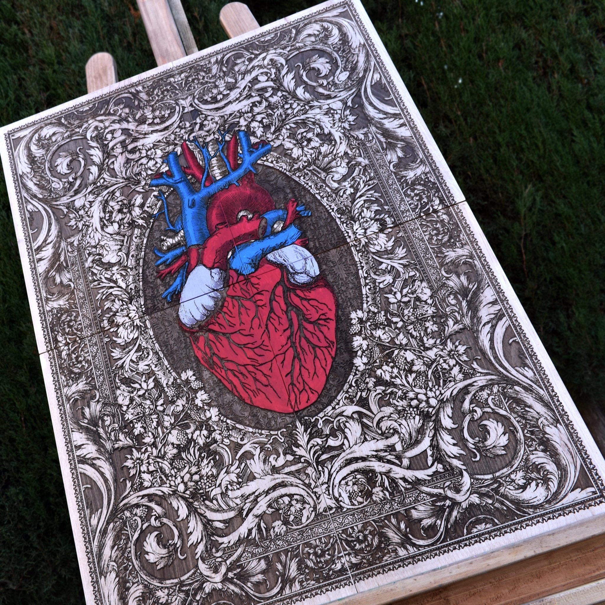 Detailed close-up of a hand-painted anatomical heart on maple wood, showcasing fine brush strokes, texture, and depth, making it a stunning decorative piece.