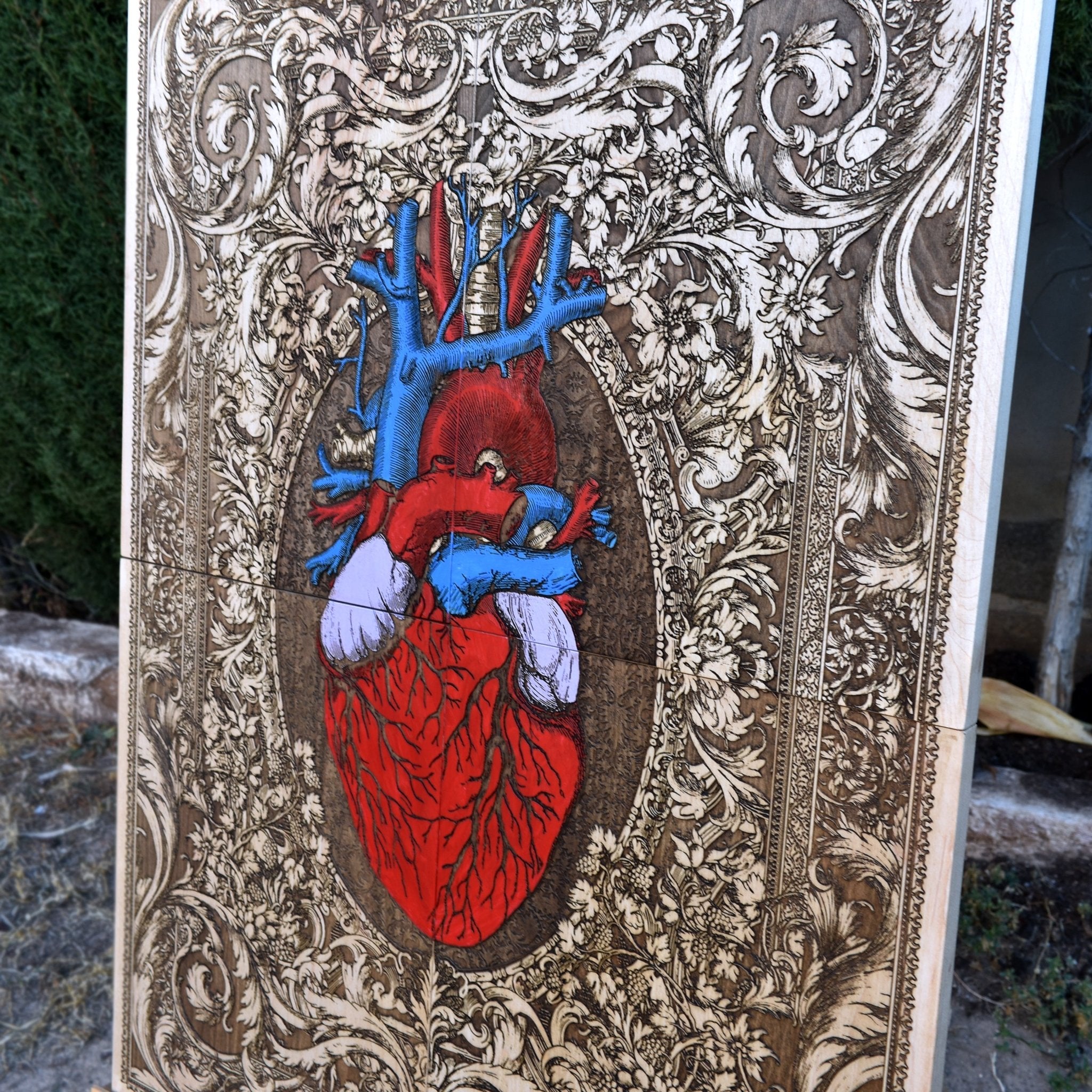 Side view of the wooden anatomical heart wall art, highlighting the thickness and natural grain of the maple wood with its hand-painted artistic details.