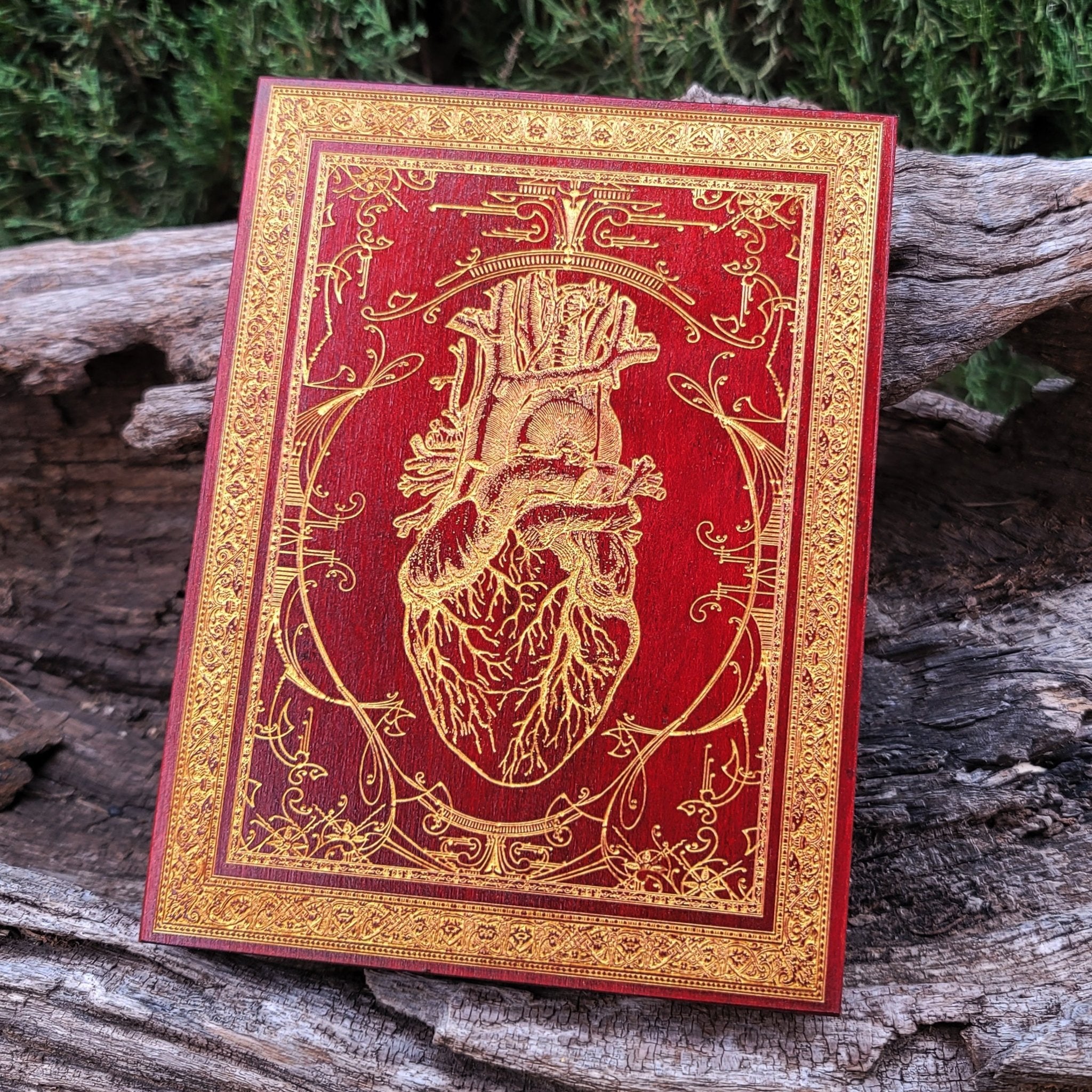 Gothic heart wall art featuring a realistic anatomical heart in red with metallic gold filling.
