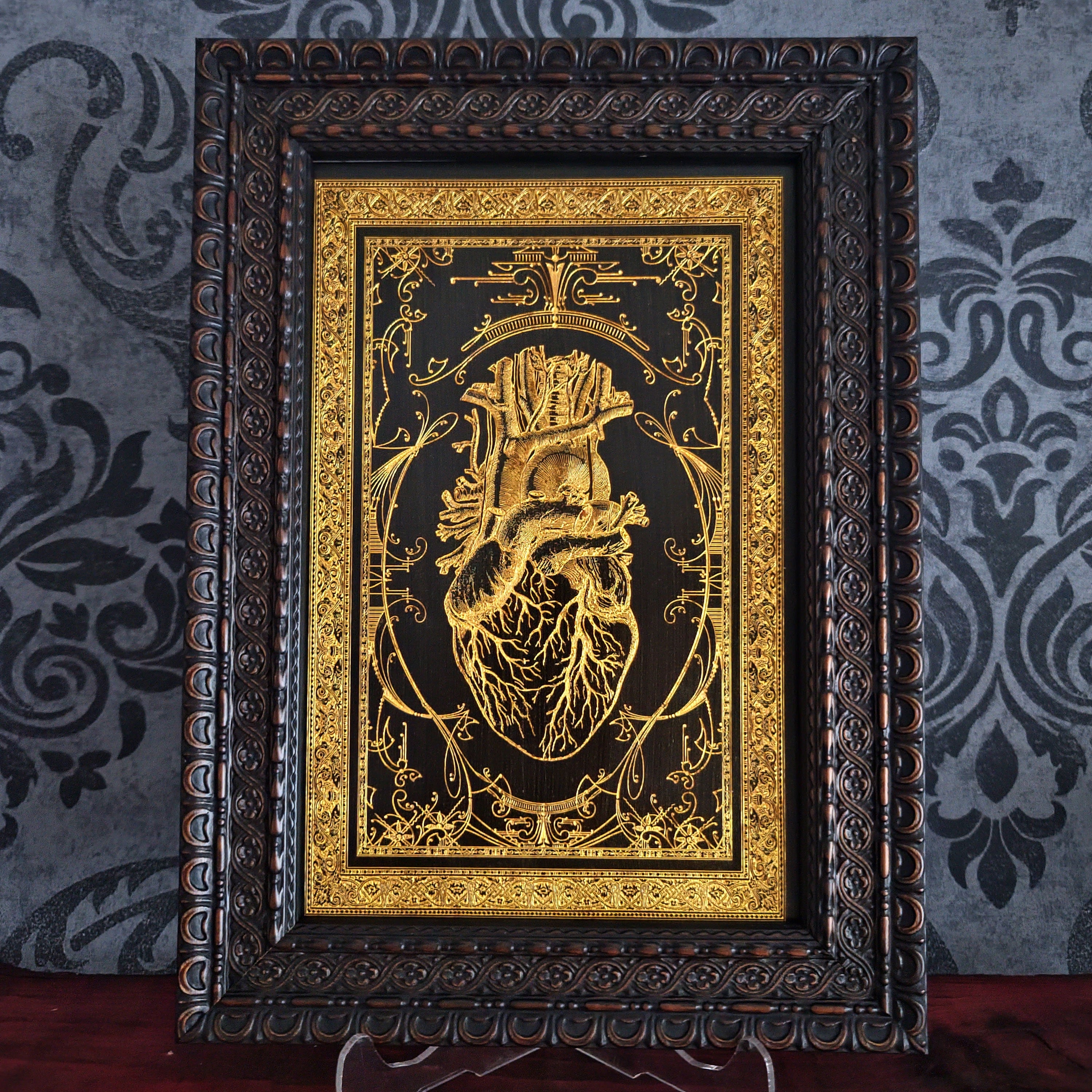 Black anatomical heart wood wall art, engraved for gothic or romantic decor.