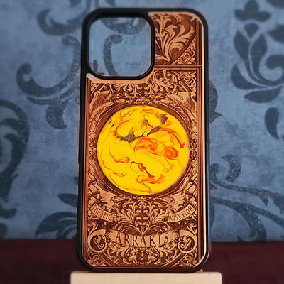 Laser engraved wood phone case with hand painted yellow desert planet, sandworm artwork, ornate frame and Arrakis design