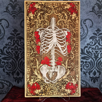 Decorative panel with a skeleton and red flowers on an ornate gold background