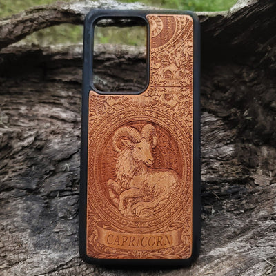 Capricorn zodiac symbol engraved on wood phone case with horoscope art