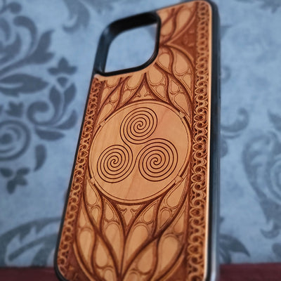 Celtic Spiral engraved wood phone case for iPhone and Galaxy with triskelion symbol in gothic wood frame.
