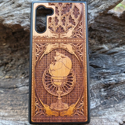 Wooden phone case with a skull inside a chalice design, intricately engraved for iPhone , Samsung Galaxy S, and more. Ideal for gothic and dark fantasy lovers, offering stylish protection for your device