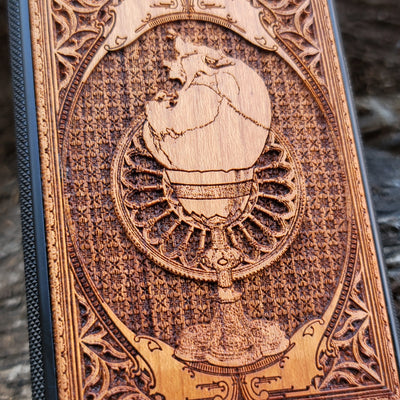 Wooden phone case with a skull inside a chalice design, intricately engraved for iPhone , Samsung Galaxy S, and more. Ideal for gothic and dark fantasy lovers, offering stylish protection for your device