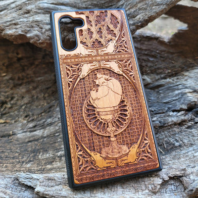 Wooden phone case with a skull inside a chalice design, intricately engraved for iPhone , Samsung Galaxy S, and more. Ideal for gothic and dark fantasy lovers, offering stylish protection for your device