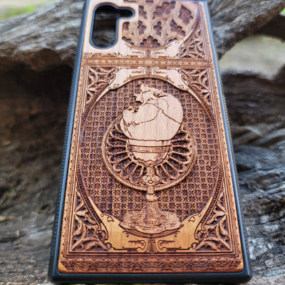 Wooden phone case with a skull inside a chalice design, intricately engraved for iPhone , Samsung Galaxy S, and more. Ideal for gothic and dark fantasy lovers, offering stylish protection for your device