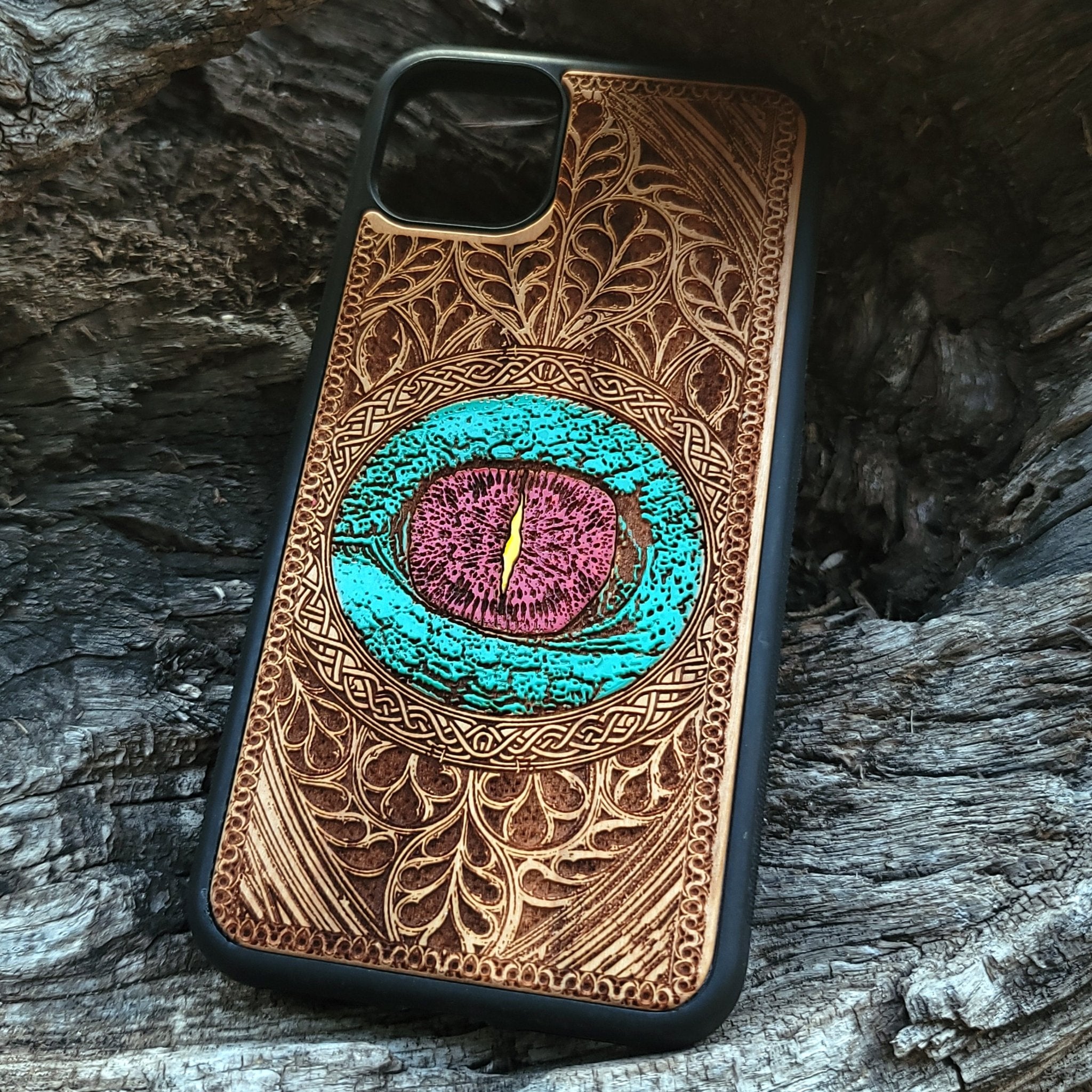 Gothic dragon eye artwork engraved on a wooden phone case, compatible with iPhone  and Samsung Galaxy S.