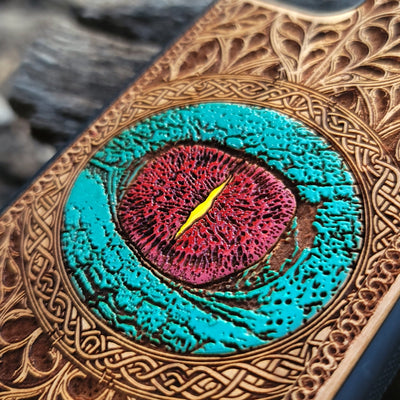 Gothic dragon eye artwork engraved on a wooden phone case, compatible with iPhone  and Samsung Galaxy S.
