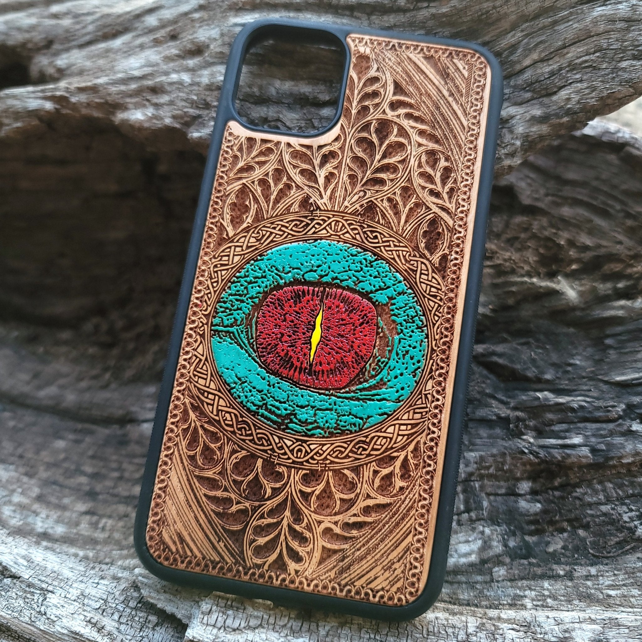 Gothic dragon eye artwork engraved on a wooden phone case, compatible with iPhone  and Samsung Galaxy S.