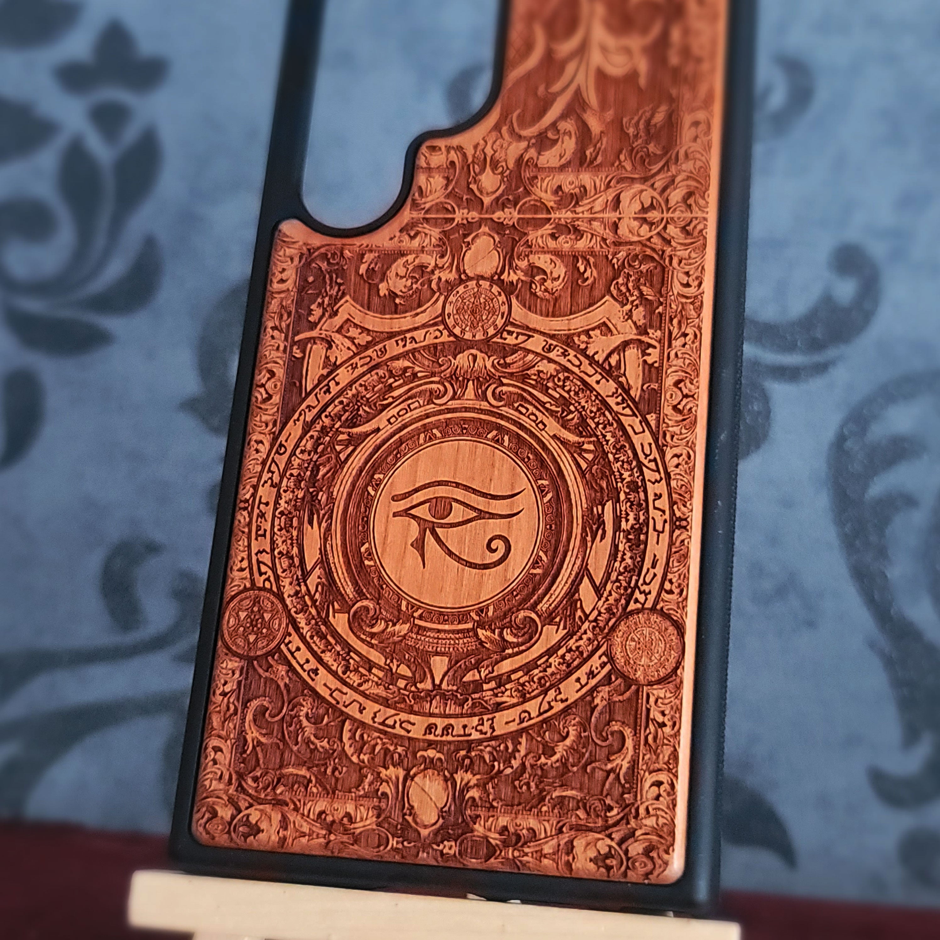 Handcrafted wooden phone case featuring a laser-engraved Eye of Horus Ra symbol. Perfect for lovers of Egyptian mythology and artistic designs. 