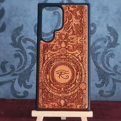 Handcrafted wooden phone case featuring a laser-engraved Eye of Horus Ra symbol. Perfect for lovers of Egyptian mythology and artistic designs. 