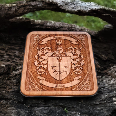Engraved wireless phone charger featuring custom family crest and shield.