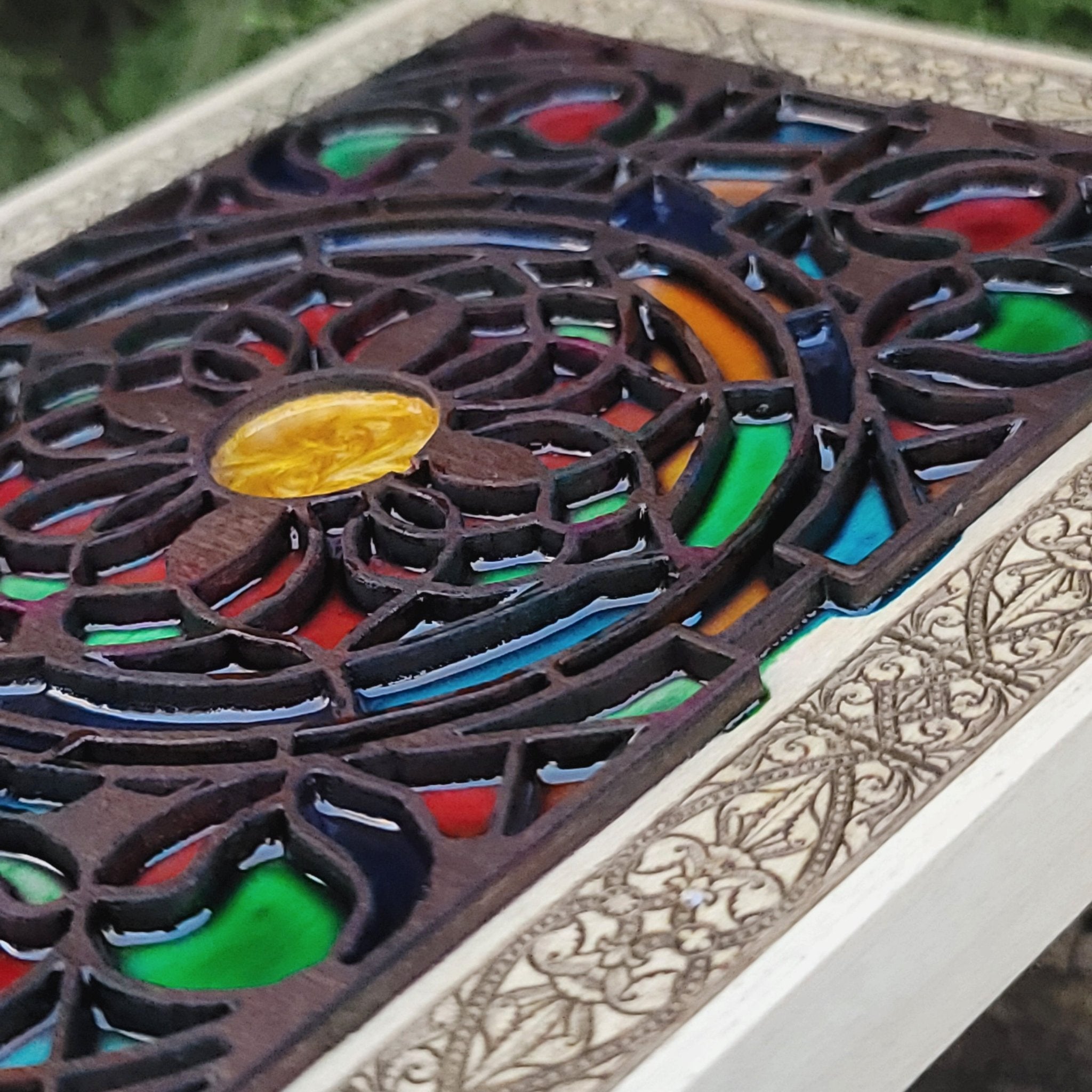 Medieval window-inspired engraved flower art on natural wood panel.