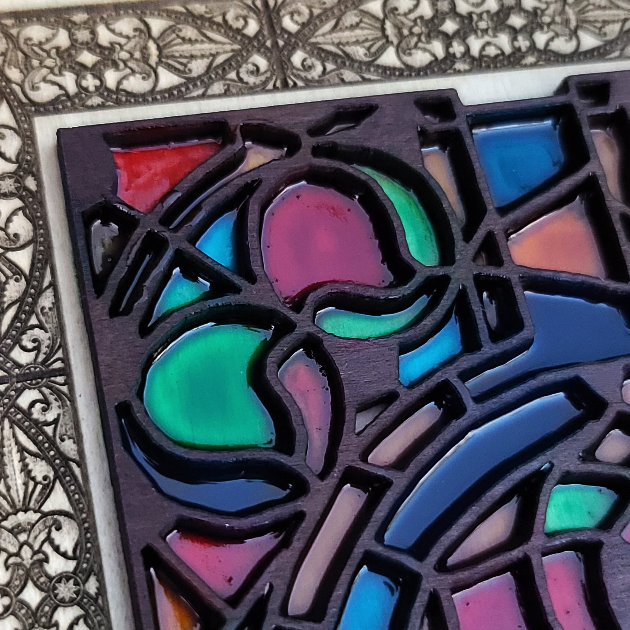 Church window-style wood art with engraved gothic floral stained glass pattern.