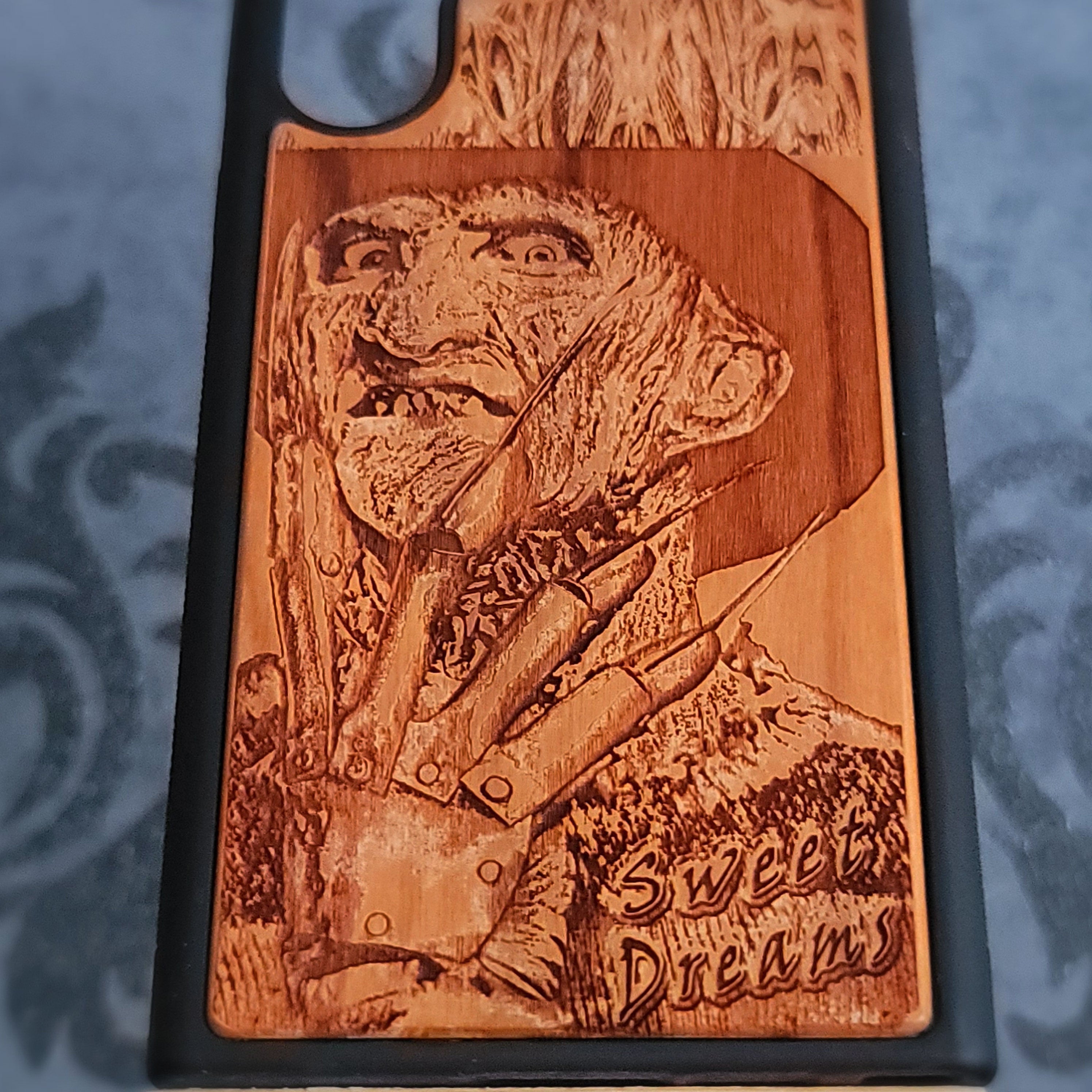 Laser-engraved wooden phone case with Freddy Krueger horror design, perfect for iPhone and Samsung Galaxy