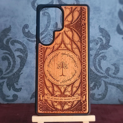 A wooden phone case with a carved design featuring the One Ring. 