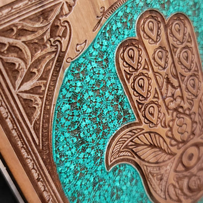 Close-up of Hamsa Hand design on wood wireless charger.