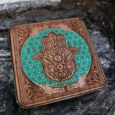 Dark wood wireless charger featuring mystical Hamsa art.