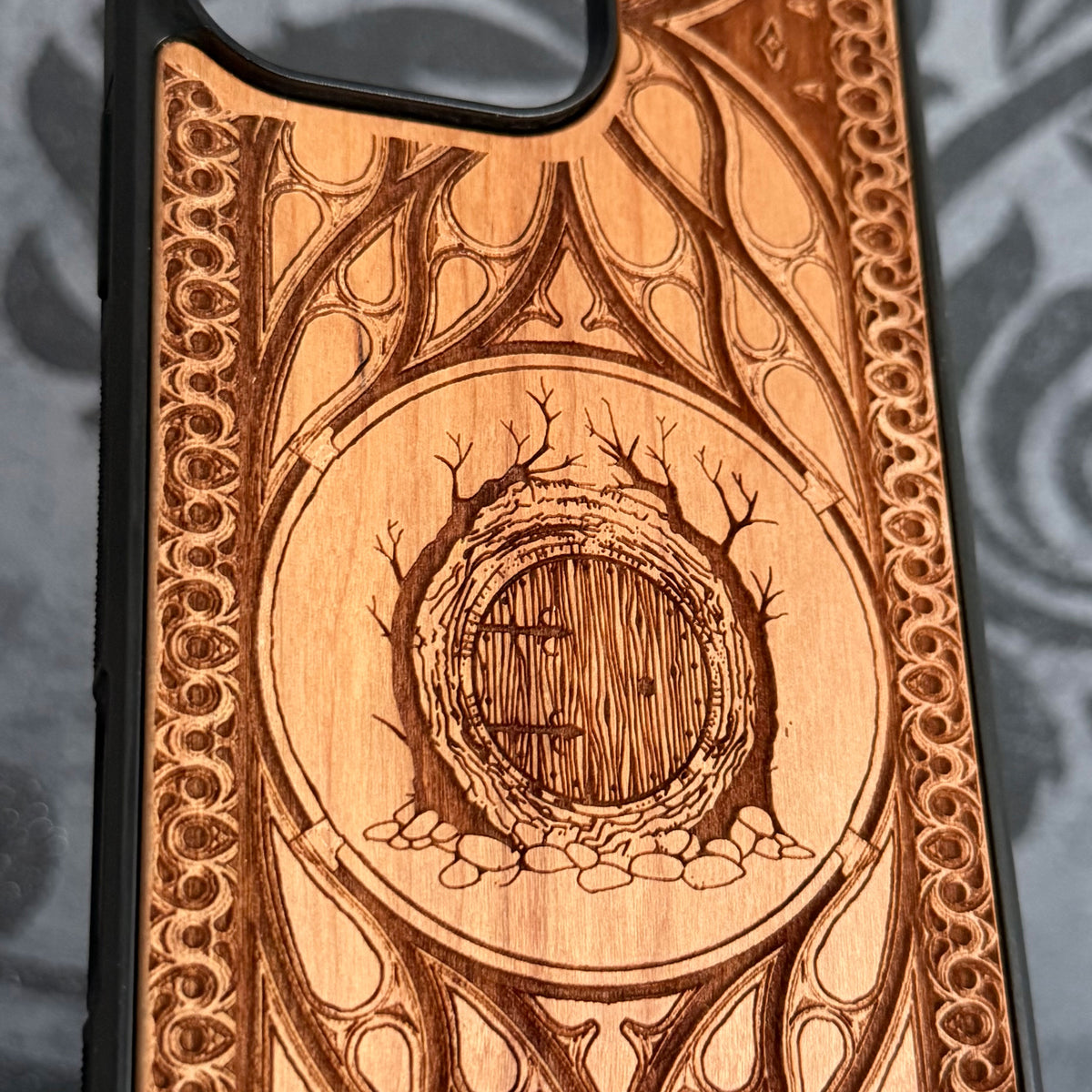 Fantasy round door cherrywood phone case with detailed ornamental engraving