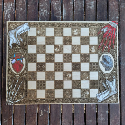 Handmade human anatomy chess board, laser engraved on wood-stained surface, perfect for 5-year anniversary gifts.