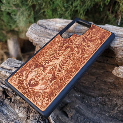 Wooden phone case with a detailed human skeleton torso and roses design, engraved for iPhone , iPhone 15, Galaxy S23 Ultra, Note 20, and more. Perfect for gothic art lovers seeking a unique phone accessory.