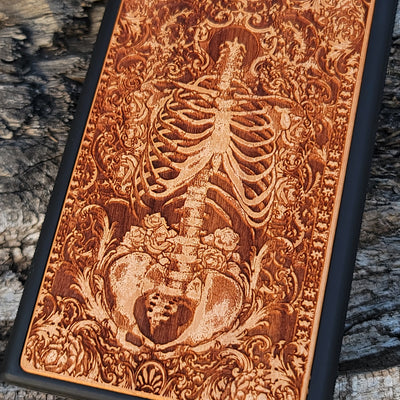 Wooden phone case with a detailed human skeleton torso and roses design, engraved for iPhone , iPhone 15, Galaxy S23 Ultra, Note 20, and more. Perfect for gothic art lovers seeking a unique phone accessory.
