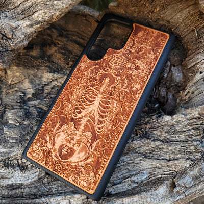 Wooden phone case with a detailed human skeleton torso and roses design, engraved for iPhone , iPhone 15, Galaxy S23 Ultra, Note 20, and more. Perfect for gothic art lovers seeking a unique phone accessory.