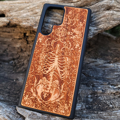 Wooden phone case with a detailed human skeleton torso and roses design, engraved for iPhone , iPhone 15, Galaxy S23 Ultra, Note 20, and more. Perfect for gothic art lovers seeking a unique phone accessory.