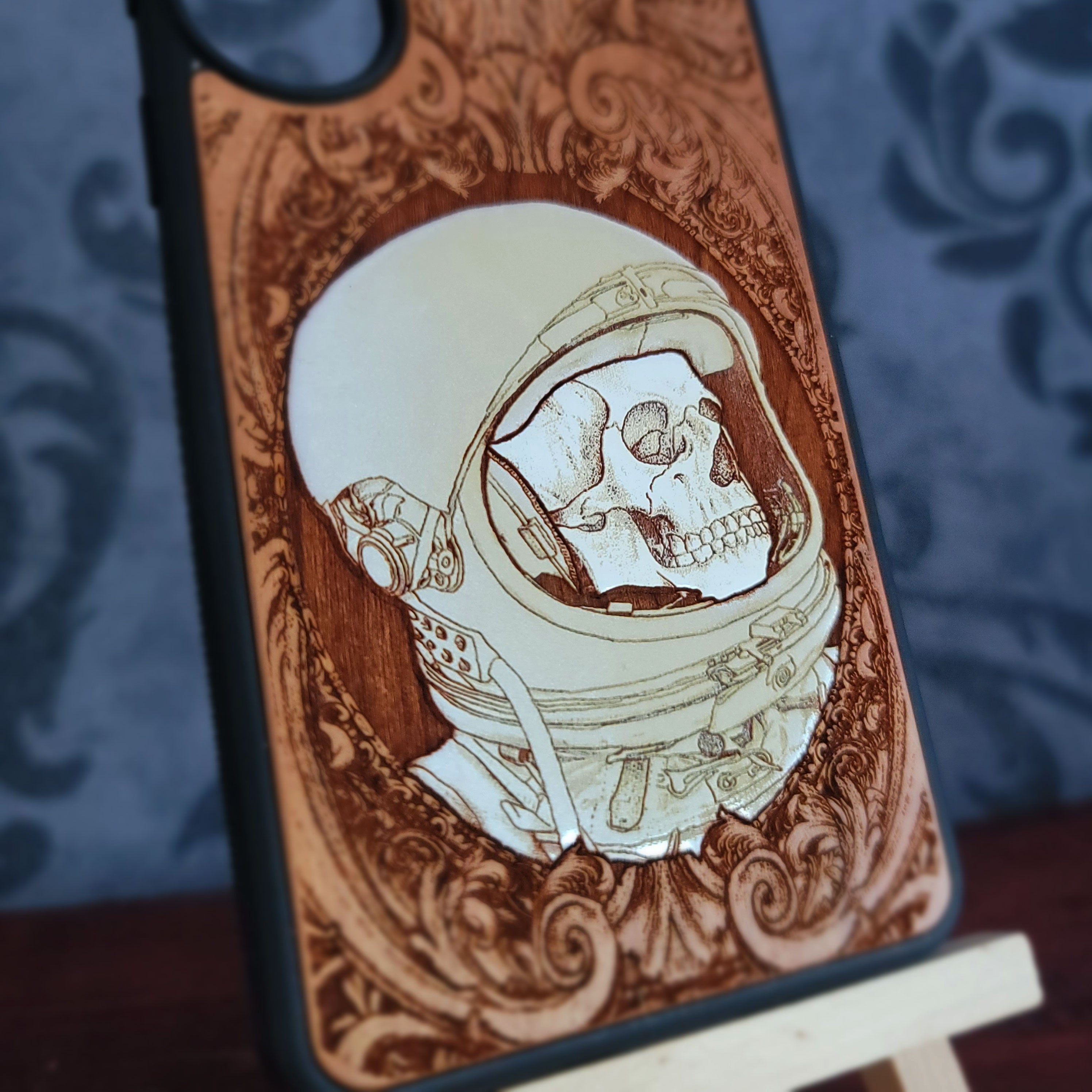 Hand-painted gothic wood phone case with astronaut skull design, compatible with iPhone  and Galaxy, featuring space horror art.