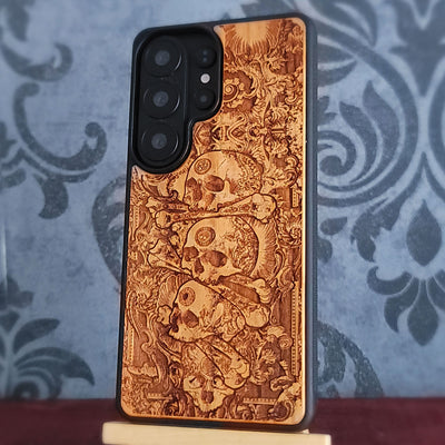 Laser engraved skull pile wood phone case with dark gothic artwork