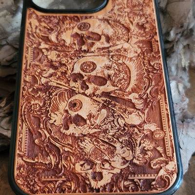Handcrafted wooden phone case with detailed skull engravings inspired by medieval church architecture, compatible with iPhone , iPhone 15, iPhone 14, iPhone 13, iPhone 12, iPhone 11 Pro Max, iPhone 11 Mini, Samsung Galaxy S, S24, S23, S22, S21, S20 Ultra Plus, and Note 20.