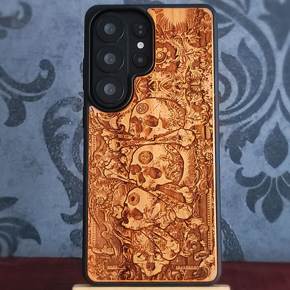 Pile of skulls engraved wood phone case with detailed gothic macabre design