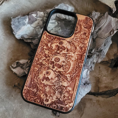 Handcrafted wooden phone case with detailed skull engravings inspired by medieval church architecture, compatible with iPhone , iPhone 15, iPhone 14, iPhone 13, iPhone 12, iPhone 11 Pro Max, iPhone 11 Mini, Samsung Galaxy S, S24, S23, S22, S21, S20 Ultra Plus, and Note 20.
